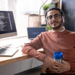 handsome programmer in headphones listening to mus 2023 11 27 04 56 48 utc